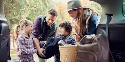 Young family packing up for camping with kids