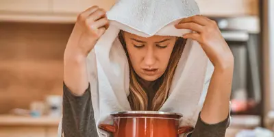 Woman doing inhalation treatment as a sinusitis remedy