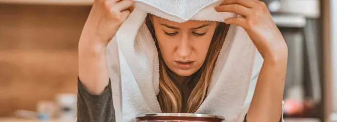 Woman doing inhalation treatment as a sinusitis remedy