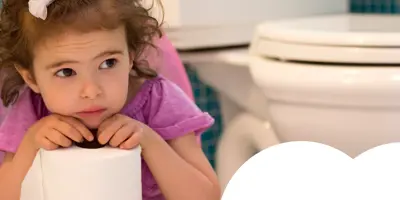 little girl holding a toilet paper roll about to learn how to wipe her bottom