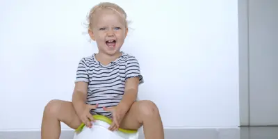 Smiling blond children peeing