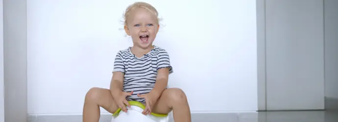 Smiling blond children peeing