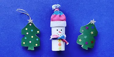 Mother and toddler daughter using toilet roll to make crafts